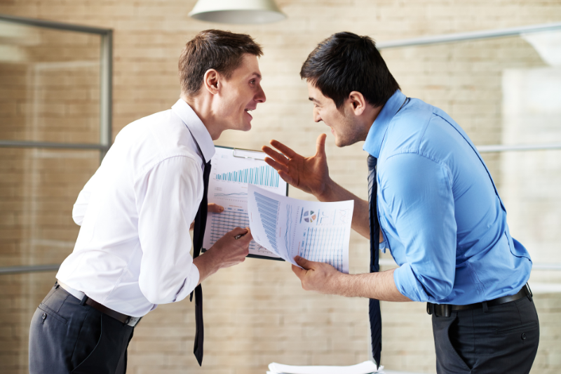 Colleagues in an argument over workplace conflicts - Mercer Legal Group services.