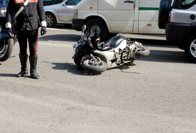 Damaged motorcycle lying on the road - Mercer Legal Group services