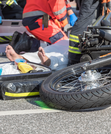 Emergency responders assisting a motorcyclist after an accident - Mercer Legal Group services