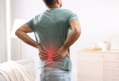 Man with back pain holding his lower back - Mercer Legal Group services