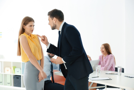 Employee dealing with workplace conflict in a group setting - Mercer Legal Group services.