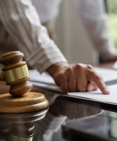 Scales of justice placed on an attorney's desk - Mercer Legal Group Services.