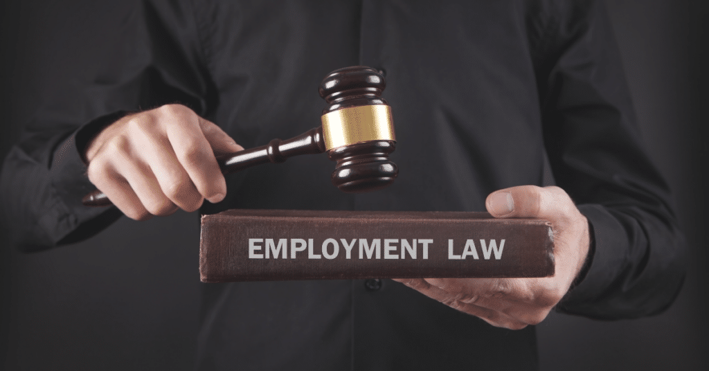 Judge's gavel resting on an employment law book representing workplace legal rights