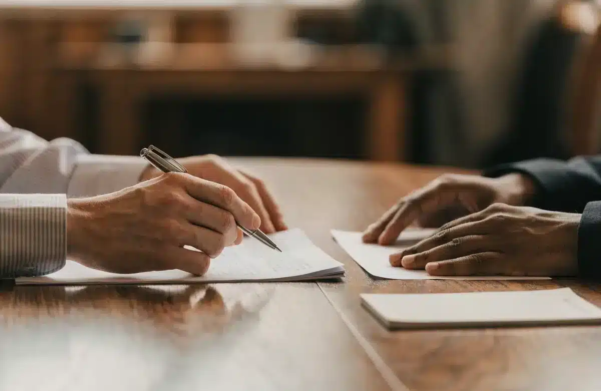 Employment attorney and client reviewing case documents across a conference table